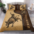 Rodeo quilt blanket styled on a bed with bull rider, cowboy boot, and Western bull artwork