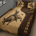Western rodeo quilt blanket featuring a bull rider, charging bull, cowboy hat, and rustic brown design