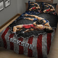 Close bedroom view of a wrestling quilt featuring two athletes grappling across a bold red and black design