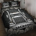 Trucker quilt blanket displayed on a bed with large chrome semi truck artwork in black and silver