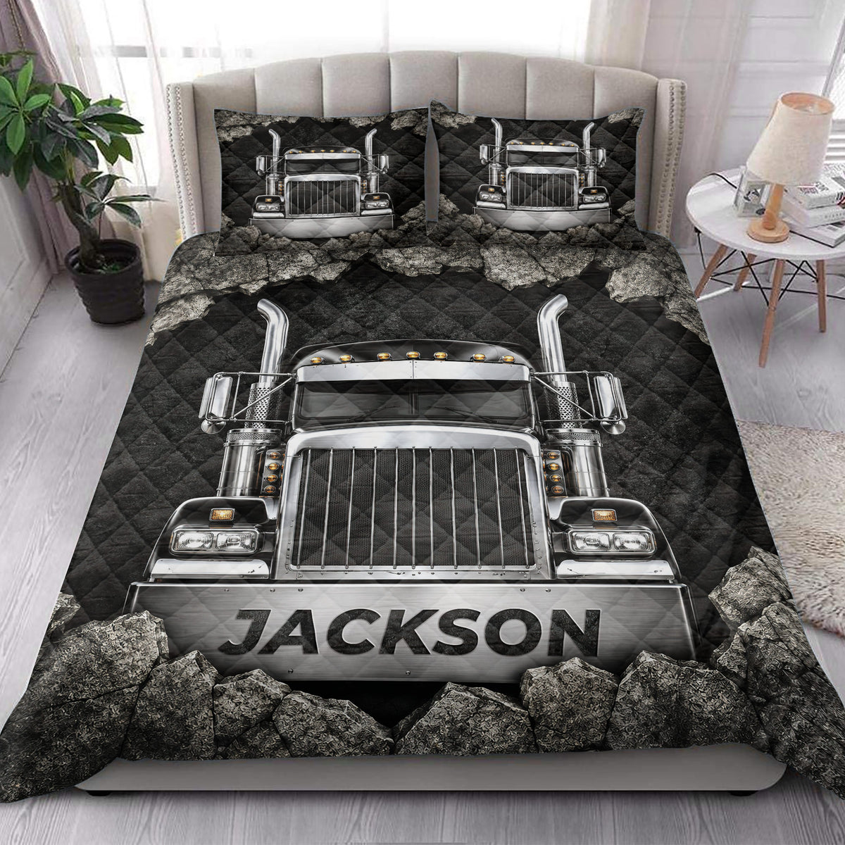 Semi truck quilt blanket styled on a bedroom bed with matching truck artwork on the pillows
