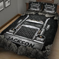 Close-up view of a black trucker quilt blanket featuring detailed chrome semi truck artwork