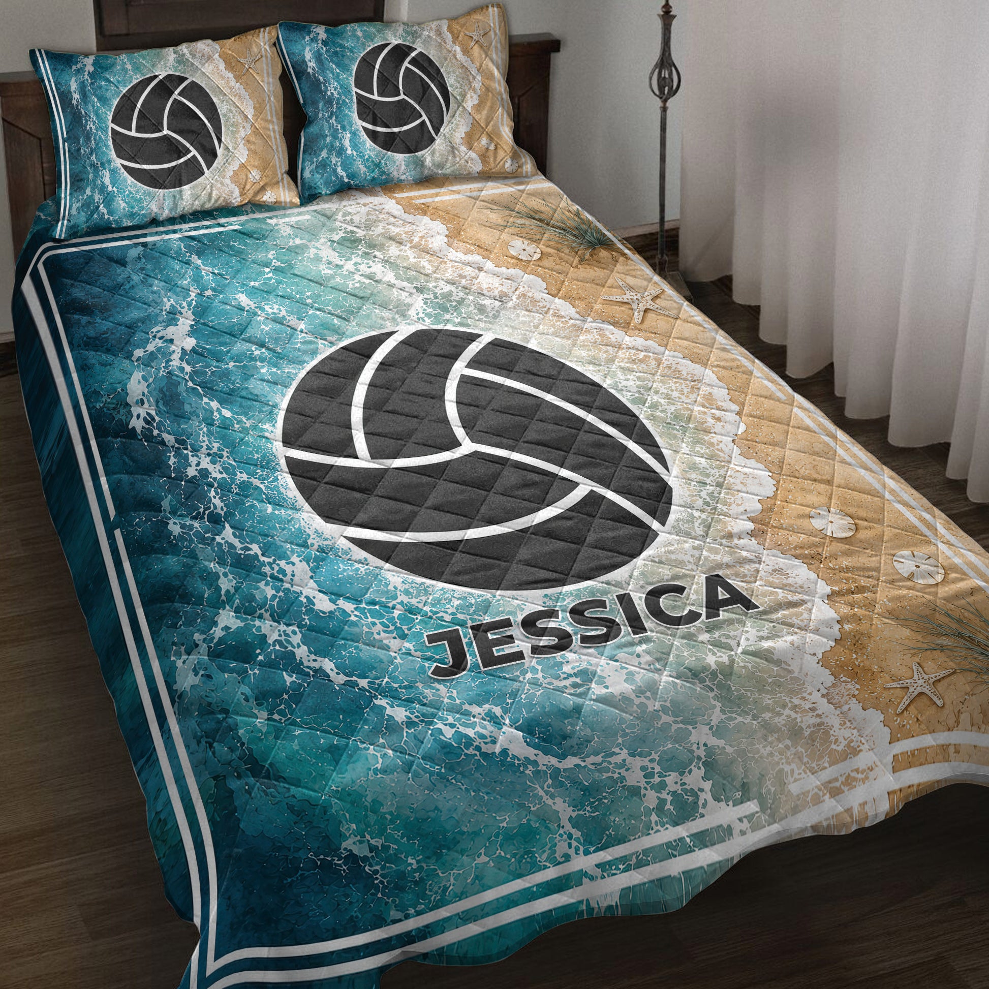 Volleyball quilt blanket displayed on a bed with ocean waves, sandy beach tones, starfish, and teal sports artwork