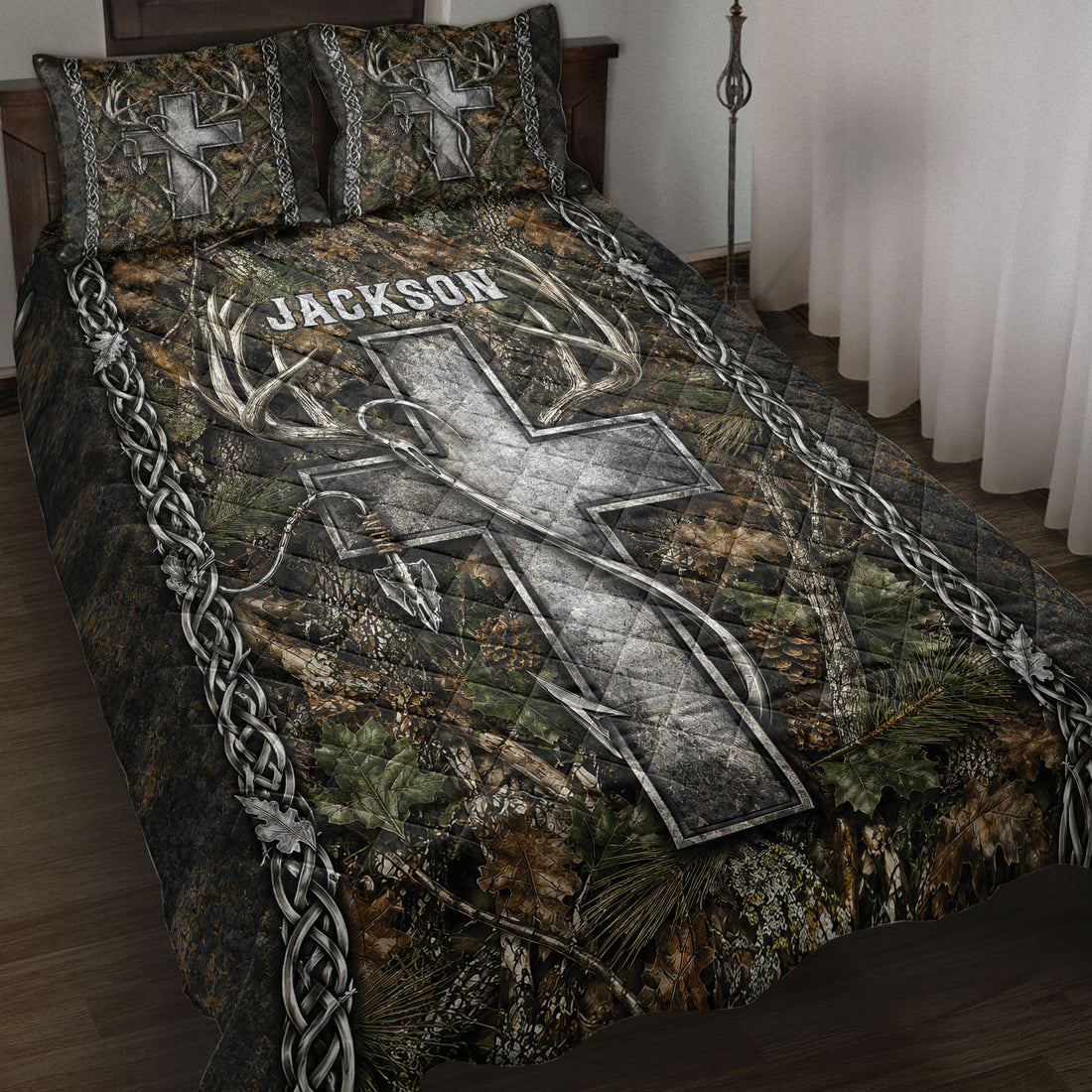 Hunting quilt blanket displayed on a bed with camouflage foliage, deer antlers, arrows, and rustic braided borders