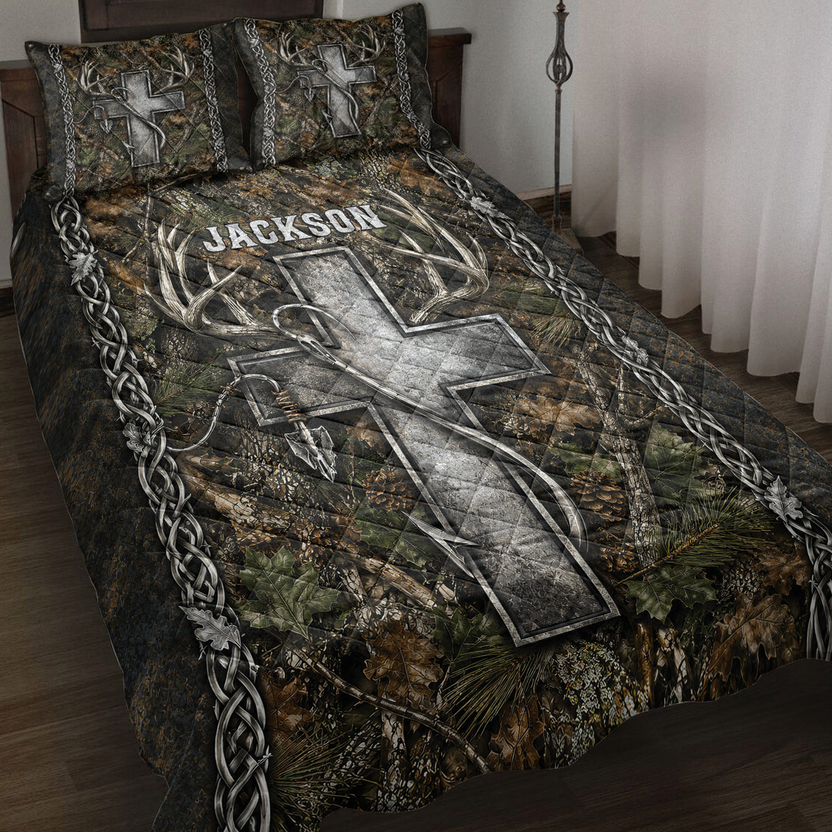 Hunting quilt blanket displayed on a bed with camouflage foliage, deer antlers, arrows, and rustic braided borders
