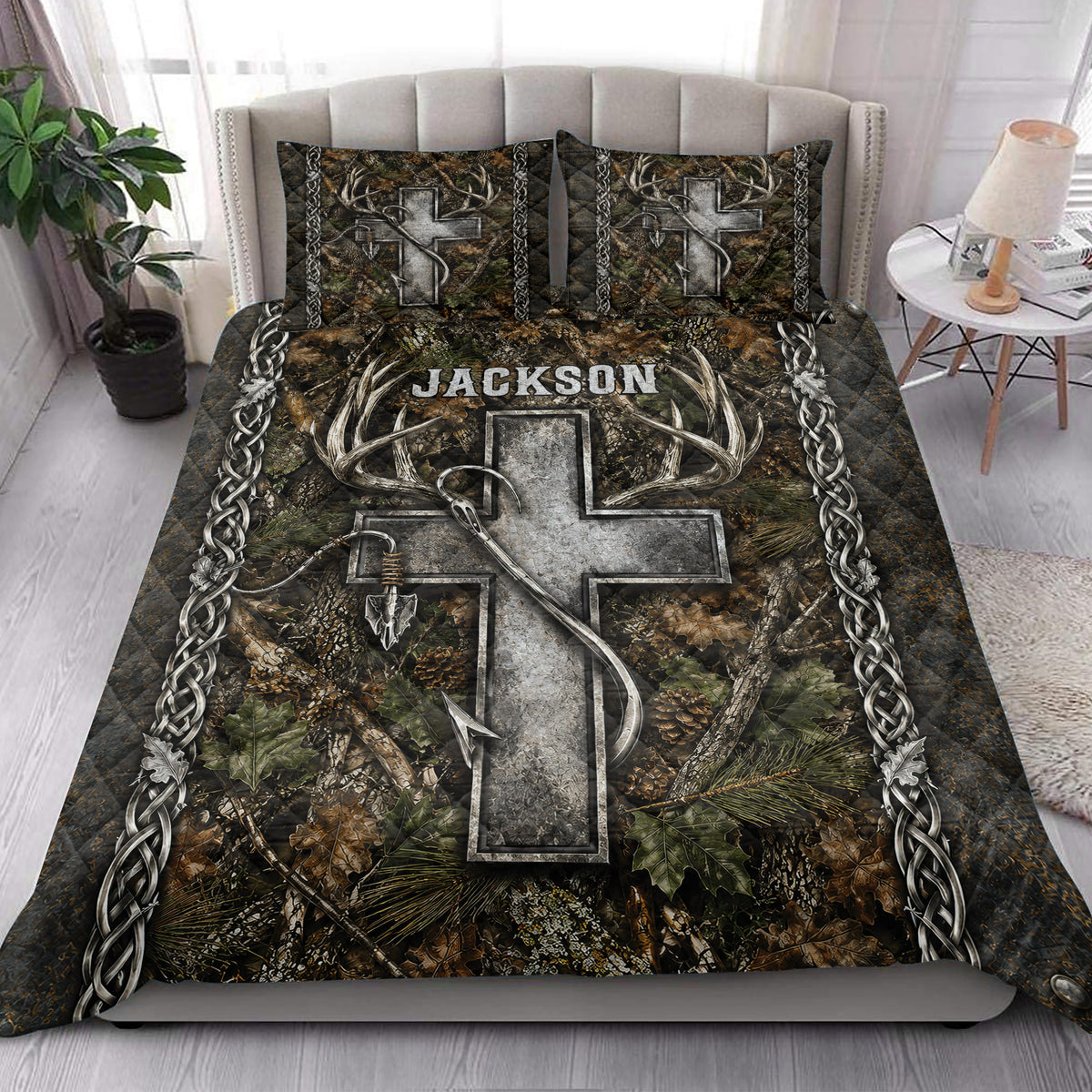 Hunting quilt blanket styled on a bedroom bed with deer antlers, camouflage leaves, arrows, and rustic outdoor artwork