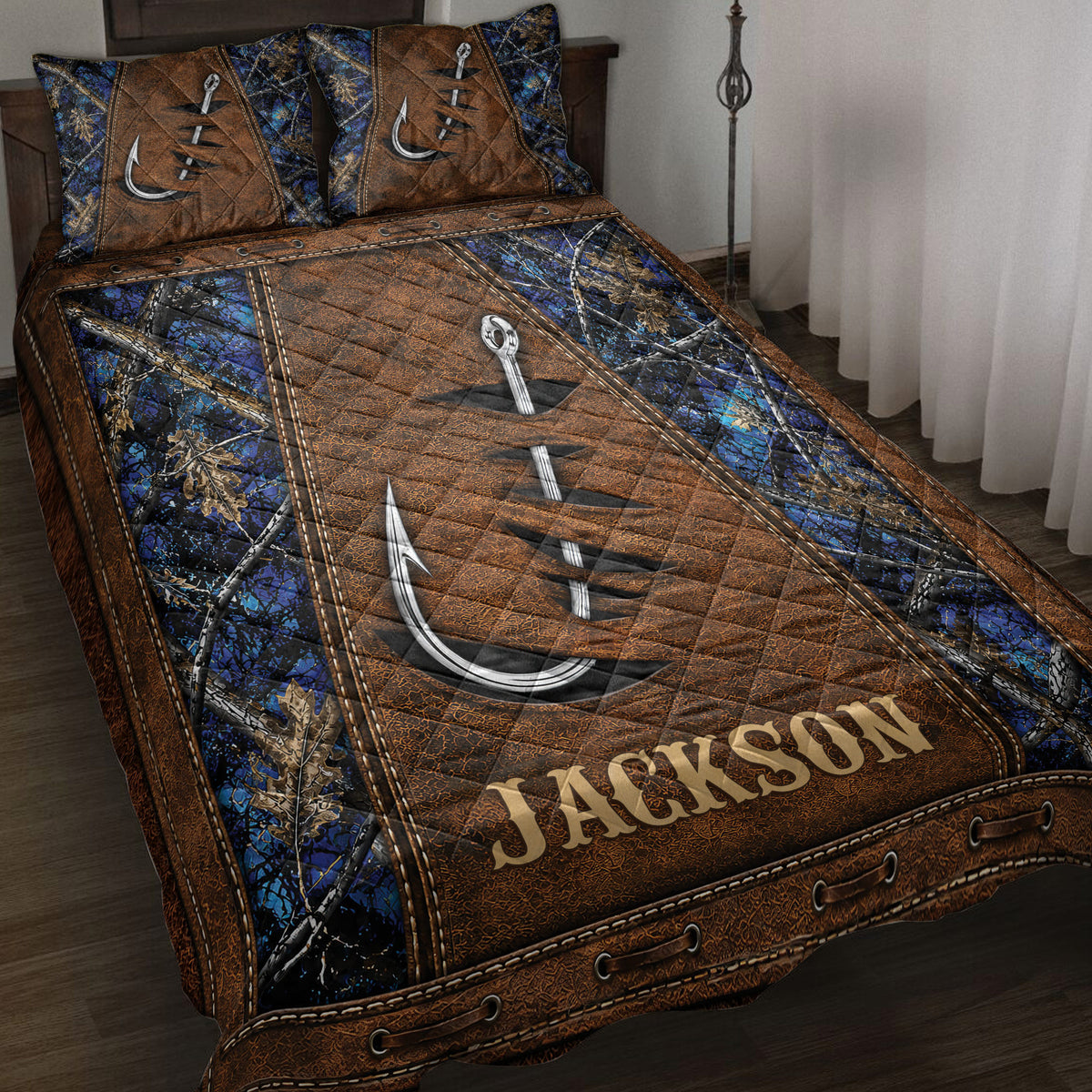 Fishing quilt blanket displayed on a bed with large hooks, woodland camouflage, and rustic brown and blue artwork