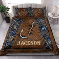 Rustic fishing quilt blanket styled on a bedroom bed with hook artwork, woodland branches, and blue camouflage