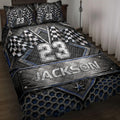 Racing quilt blanket displayed on a bed with checkered flags, metallic graphics, and blue black bedroom decor