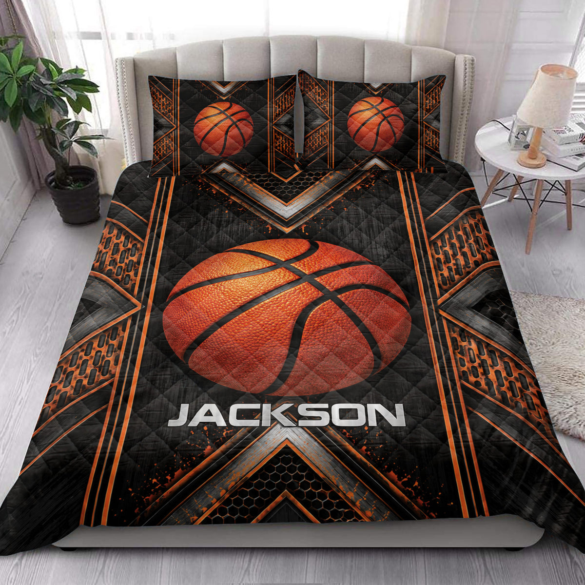 Basketball quilt bedding styled on a bedroom bed with large orange basketball and black sports design