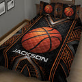 Close view of basketball quilt blanket featuring a large orange basketball and dramatic black-orange pattern