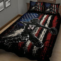 Close bedroom view of a baseball quilt blanket featuring a batter-inspired player illustration and red, white, and blue design