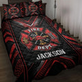 Firefighter quilt blanket displayed on a bed with bold red and black fire department crest artwork