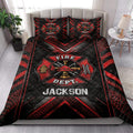 Firefighter quilt bedding styled in a bedroom with bold red and black fire department artwork