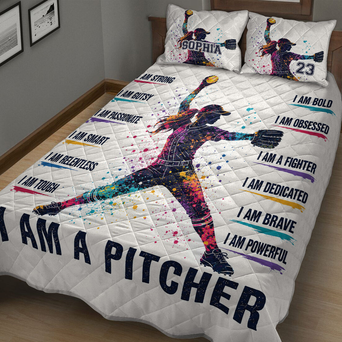 Angled bedroom view of a colorful softball quilt blanket featuring a female pitcher and motivational sports artwork
