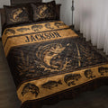 Fishing quilt blanket displayed on a bed with bass artwork, fishing rods, water splashes, and rustic black and gold styling