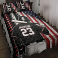 Baseball quilt blanket displayed on a bed with batter artwork, stars, and distressed red, white, and blue stripes