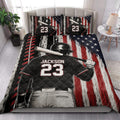 Baseball quilt blanket styled on a bedroom bed with dramatic batter artwork and patriotic red, white, and blue colors
