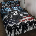 Hockey quilt blanket displayed on a bed with rink lights, ice action, player artwork, and patriotic red, white, and blue details