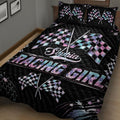 Close angled view of a black racing quilt blanket with crossed pastel checkered flags and star accents