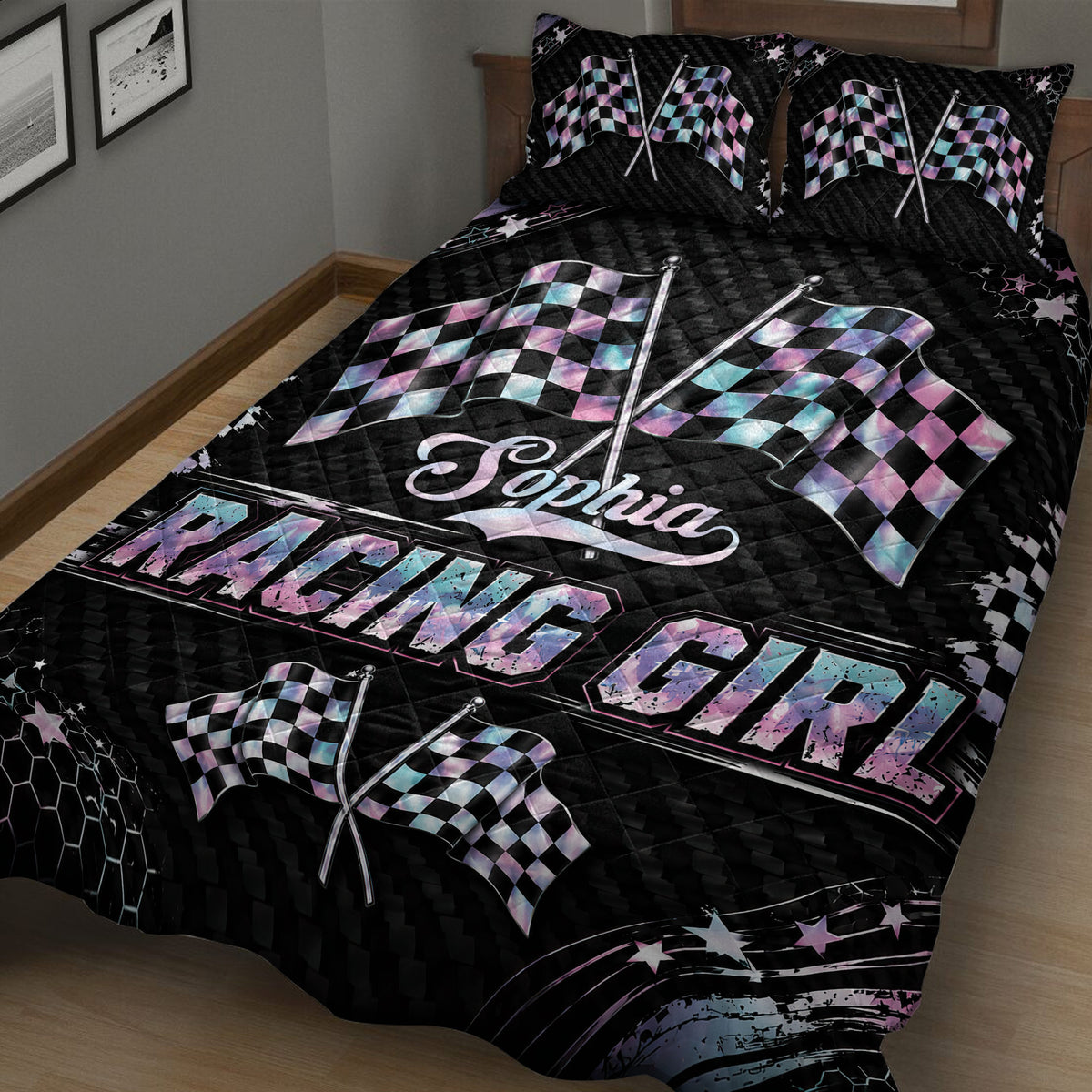 Close angled view of a black racing quilt blanket with crossed pastel checkered flags and star accents