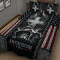 Patriotic wrestling quilt blanket displayed across a bed with grappling artwork and star details