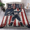 Patriotic hockey quilt blanket styled on a bedroom bed with bold navy, red and white artwork