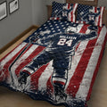 Hockey player quilt blanket displayed across a bed with stars, stripes and action-inspired artwork