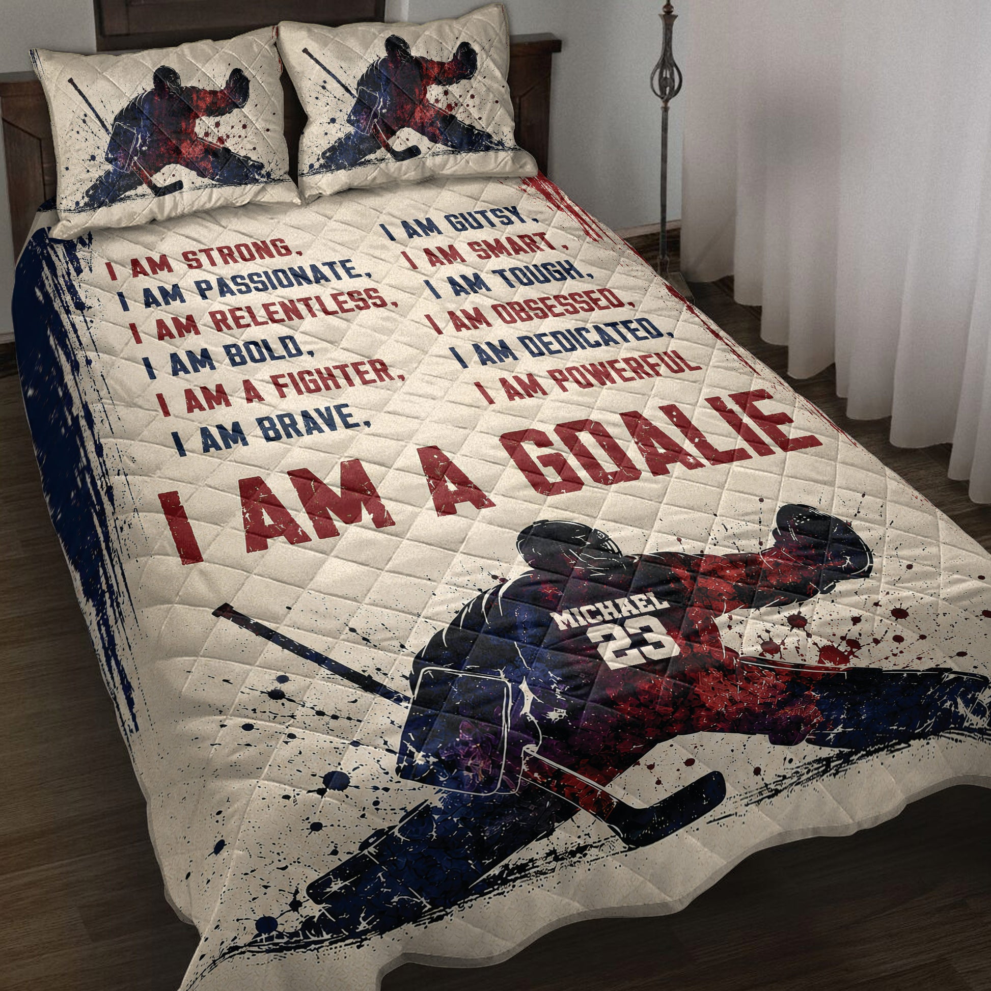 Hockey quilt blanket bedding set displayed on a bed with red and navy player artwork and motivational sports typography