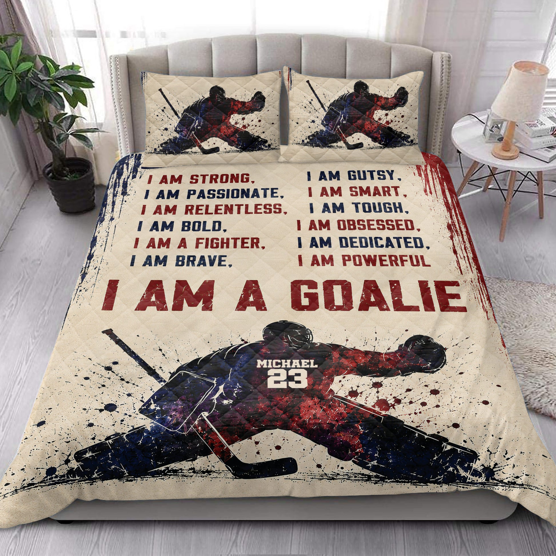 Hockey quilt blanket styled in a bright bedroom with matching hockey player artwork and bold red and navy graphics