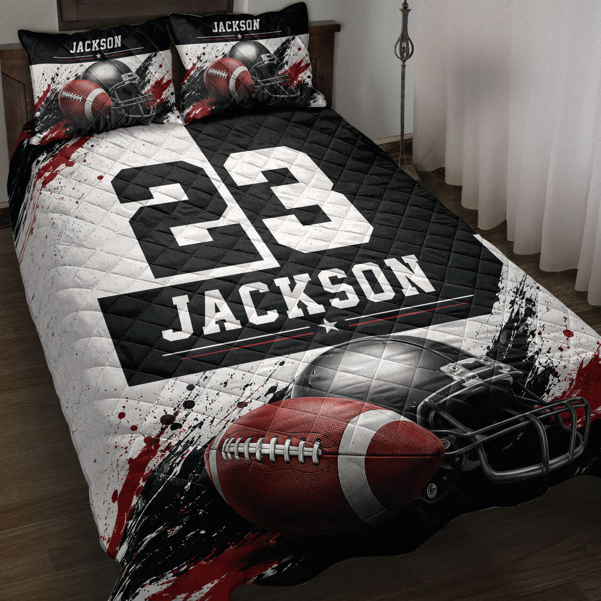 Football quilt blanket displayed on a bed with helmets, footballs, bold black and red artwork, and custom-style sports design