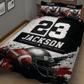 Close view of football quilt bedding with dramatic helmet and football artwork in black, white, and red