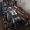 American football quilt blanket displayed on a bed with helmeted player artwork and patriotic red, white, and blue design