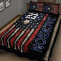 Close bedroom view of baseball quilt blanket featuring baseball bats, a baseball, stars, and flag-inspired stripes