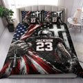 American football quilt blanket styled on a bedroom bed with dramatic black, red, white, and blue artwork