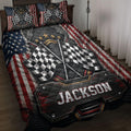 Racing quilt blanket displayed on a bed with crossed checkered flags, American flag accents, and bold black and red artwork