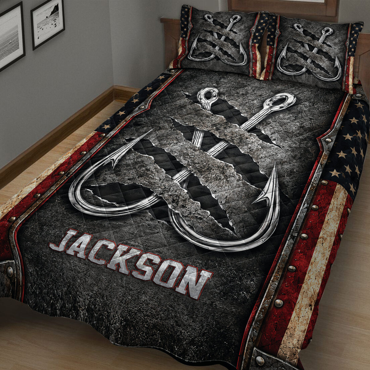 Close bedroom view of a fishing quilt blanket featuring oversized hooks, dark distressed texture, and red accents