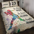 Softball quilt blanket displayed on a bed with colorful batter artwork and motivational sports graphics