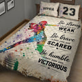 Close view of a softball quilt blanket featuring a colorful batter silhouette and motivational artwork
