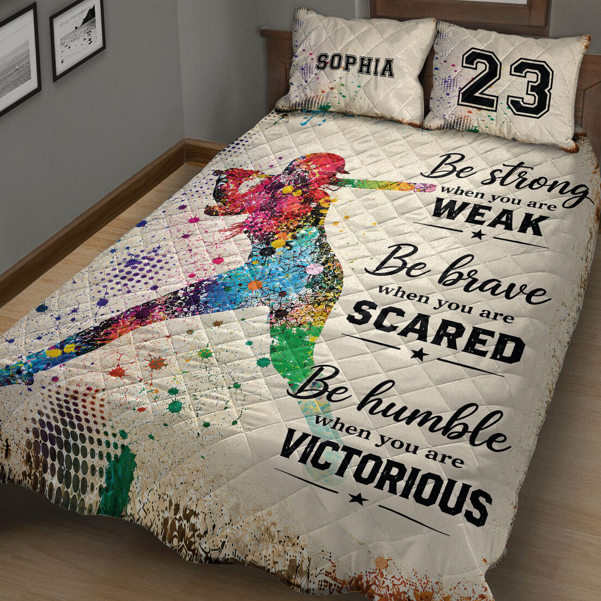 Close view of a softball quilt blanket featuring a colorful batter silhouette and motivational artwork