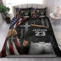 Patriotic baseball quilt bedding styled on a bed with ballplayer artwork, stars, flag colors, and cross details