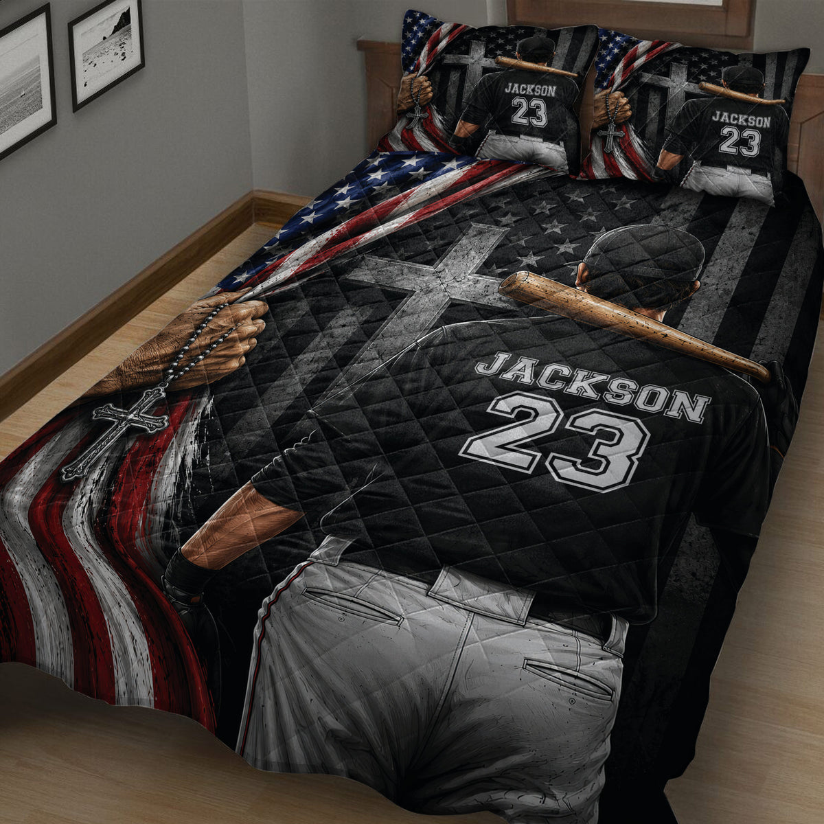 Close bedroom view of a baseball quilt featuring a ballplayer from behind, bat, glove, stars, and red white and blue artwork