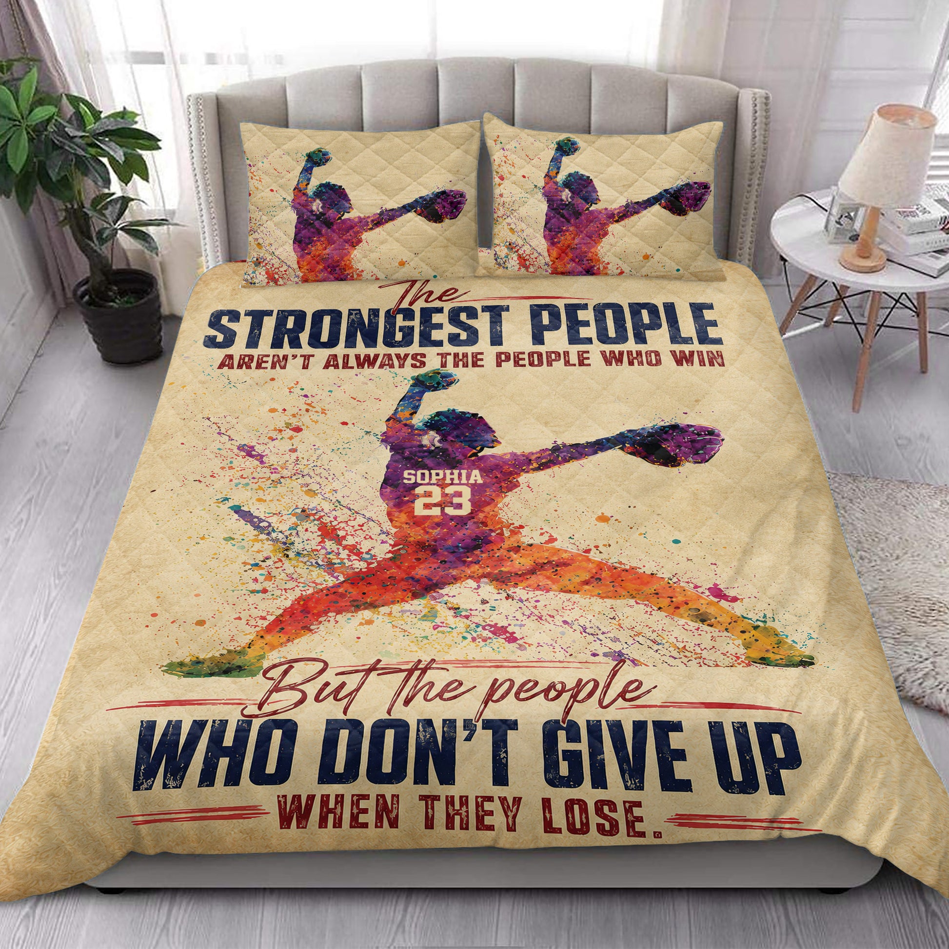 Colorful softball pitcher quilt blanket styled in a bright bedroom with matching sports artwork