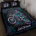 Black motocross quilt blanket on a bed with neon purple and blue dirt bike artwork