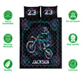 Motocross quilt bedding set with neon dirt bike artwork and floral border on a black background