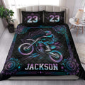 Motocross quilt blanket styled on a bedroom bed with colorful dirt bike artwork