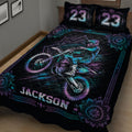 Close bedroom view of a black motocross quilt with rider and dirt bike artwork