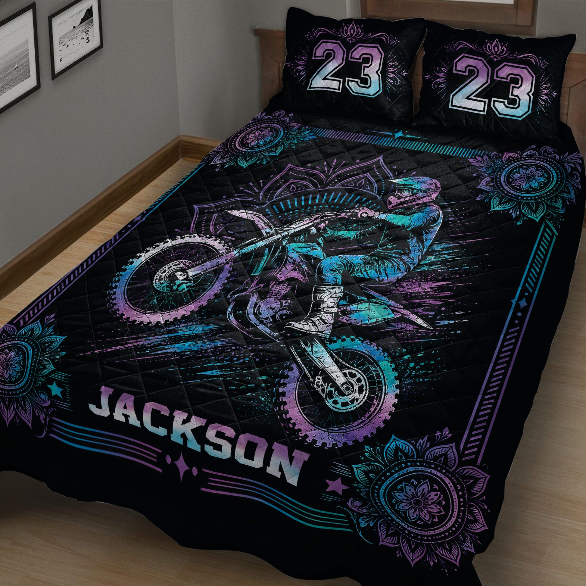 Close bedroom view of a black motocross quilt with rider and dirt bike artwork