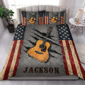 Guitar quilt bedding styled in a bright bedroom with acoustic guitar artwork and rustic flag accents