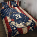 Baseball quilt blanket displayed on a bed with patriotic stars and stripes and ballplayer artwork